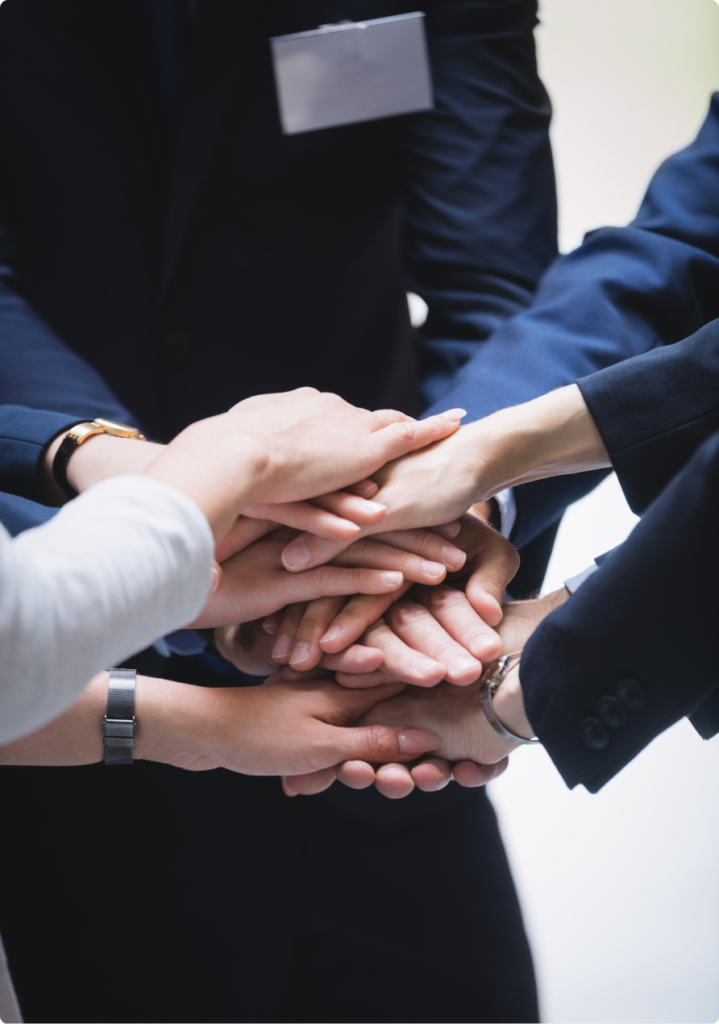 Team members link arms, symbolizing unity and cooperation.